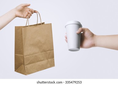 Hand Holding Paper Bag And Cup For Your Design Presentation