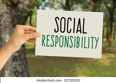 Hand Holding A Paper Card With  Social Responsibility Concept On Abstract Nature Background