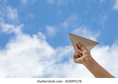 Hand Holding Paper Plane On Sky Background