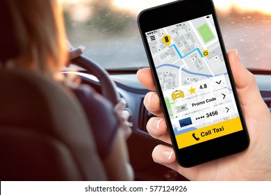 hand holding phone with application call taxi on screen background woman driving car