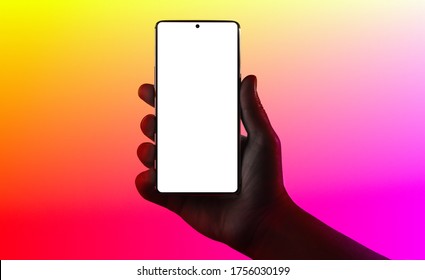Hand holding phone. Silhouette of male hand holding smartphone isolated on multicolored background. Bezel-less screen is cut with clipping path.