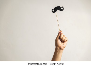 Hand holding Photo booth props, Black Mustache and rising it up