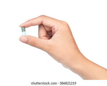 Hand Holding A Pill Between Thumb And Forefinger Isolated On White Background