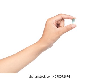 Hand Holding A Pill Between Thumb And Forefinger Isolated On White Background