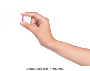 Hand Holding A Pill Between Thumb And Forefinger Isolated On White Background