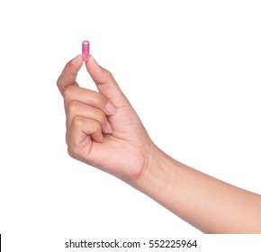 Hand Holding A Pill Between Thumb And Forefinger Isolated On White Background