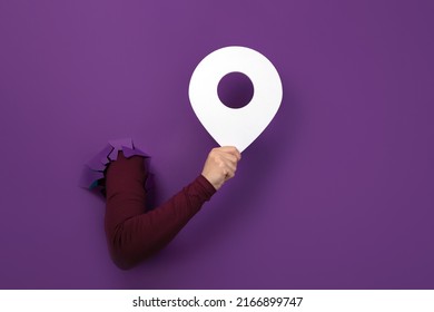 Hand Holding Pin Over Purple Background