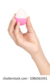 hand holding Pink egg beauty sponge isolated on a white background