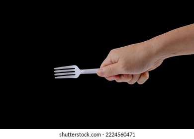 Hand Holding A Plastic Fork On Black Background