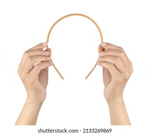 Hand holding Plastic Hair Headband isolated on white background