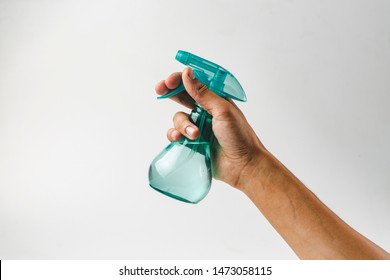 Hand holding plastic spray bottle - hold plastic spray bottle isolated on white. Man with water sprayer in hand. - Powered by Shutterstock