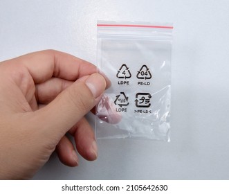 Hand Holding A Plastic Ziplock Bag Isolated On White Background