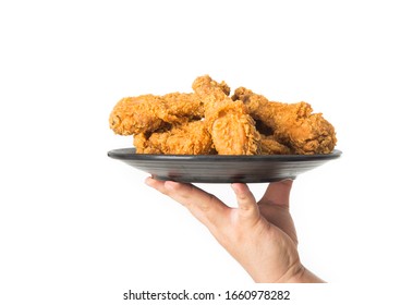 Hand Holding A Plate Of Fried Chicken Isolated On White Background