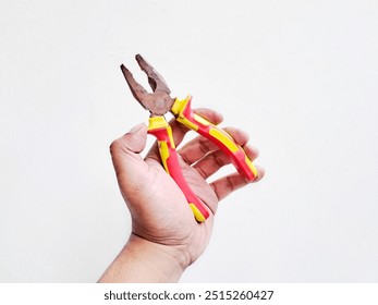 Hand holding pliers, home carpentry tools on white background, Isolated White - Powered by Shutterstock