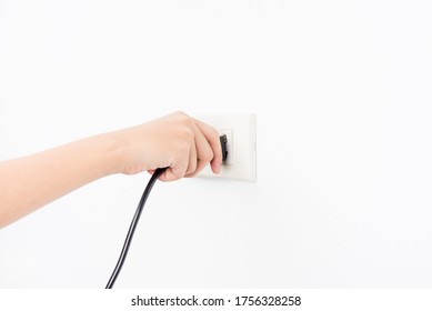 Hand holding plug , Unplug or plugged on white wall background safety concept