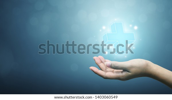 Hand holding plus sign virtual means to\
offer positive thing (like benefits, personal development, social\
network, health insurance) with copy\
space
