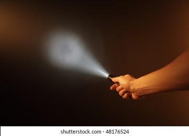 Hand Holding Pocket Flashlight