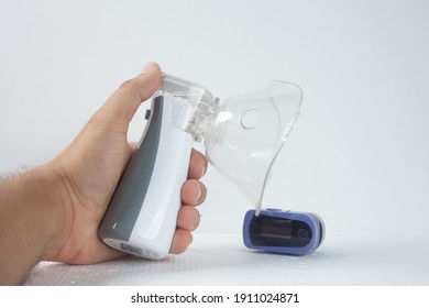 Hand Holding A Portable Nebulizer
