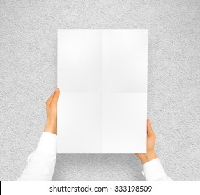 Hand Holding Poster Mock Up. Nice Mockup To Show Your Design, Picture Or Illustration. Blank Sheet In Hands Near The Textured Wall. Display Movie Theatre Cinema Film With Poster Holder. Leaf Design.