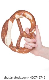 Hand Holding Pretzel Over White Background