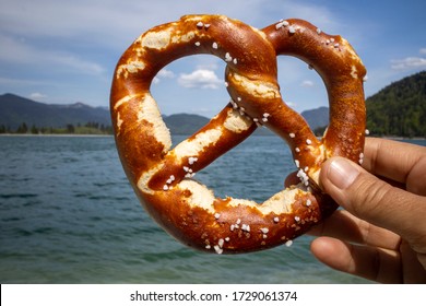 Hand Holding A Pretzel At Walchensee