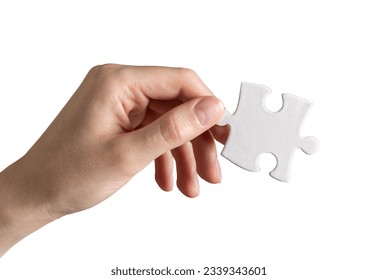Hand holding puzzle piece, jigsaw element isolated on white background.
