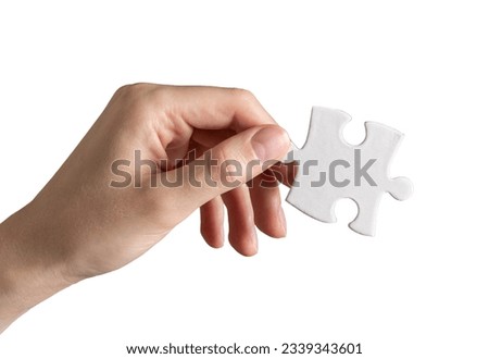 Hand holding puzzle piece, jigsaw element isolated on white background.
