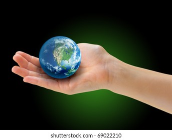 Hand holding realistic small globe symbolizing environmental care, facing North America