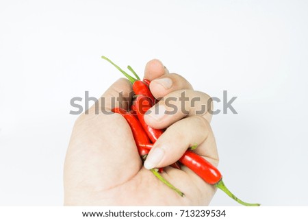 Hand holding red chili with white background