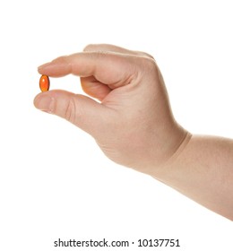 Hand Holding Red Gel Capsule Isolated Over White Background