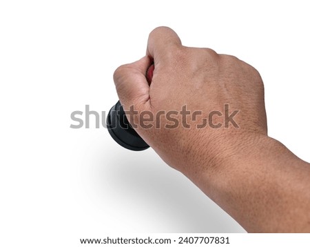 Hand holding red handled round rubber stamp, top view isolated on white with copy space