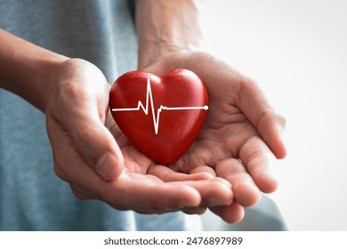 Hand holding Red heart with pulse in man's hands. - Powered by Shutterstock