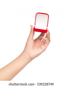 Hand Holding A Red Velvet Box For The Ring Isolated On A White Background.