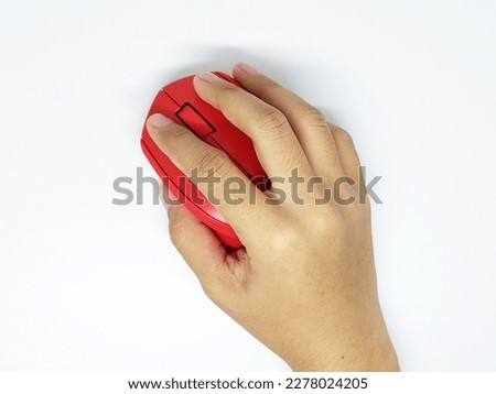 Hand holding red wireless mouse isolated on white background