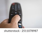 Hand holding a remote controller Watching TV