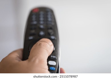 Hand holding a remote controller Watching TV