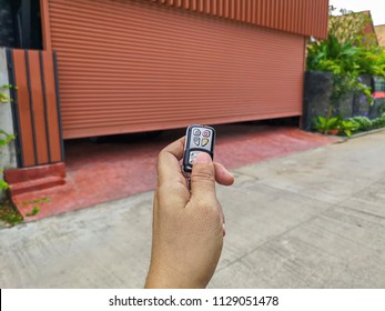 Hand Holding The Remote To Open The Sliding Door.Remote Control Door.Electrical Door.Automatic Door.