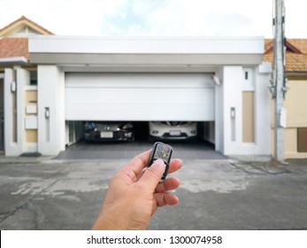 Hand Holding The Remote To Open The Sliding Door.Remote Control Door.Electrical Door.Automatic Door.