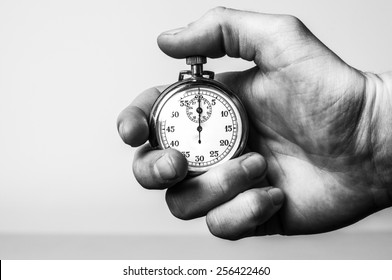 Hand holding retro stopwatch in black & white - Shutterstock ID 256422460