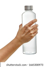 Hand holding reusable glass bottle with drinking water isolated on white background