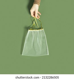 Hand Holding Reusable Grocery Bags From Net, Reusable Packaging For Fruits And Vegetables, Set Eco Mesh Bag With Colored Ribbon Ties, Eco Friendly And Zero Waste Concept, Minimal Style, Top View