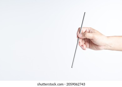 Hand Holding Reusable Stainless Steel Or Silver Straws For Drink On White Background