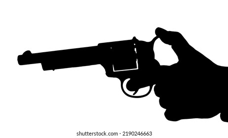 A Hand Holding A Revolver Gun, Loading The Bullet Into The Cylinder, Preparing To Fire. Silhouette Shot.
