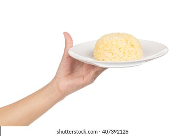 hand holding rice in a plate / a portion of cooked yellow rice in white ceramic dish