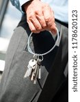 A hand holding ring with keys.