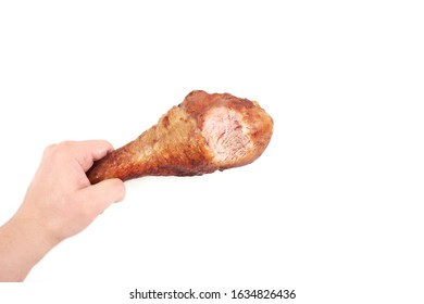 Hand Holding Roasted Turkey Leg With Bite Taken , Isolated On White Background.