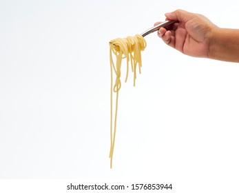 Hand Holding Roll Pasta Spaghetti With A Fork On White Background. Space For Text.