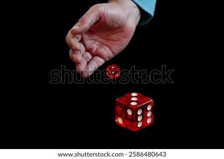 Hand holding, rolling two dices isolated on dark background, take a chance to lucky opportunity concept