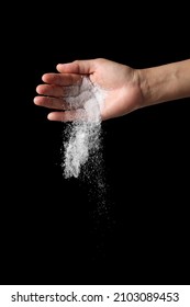 Hand Holding Salt Isolated On Black Background