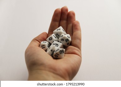 Hand Holding The Set Of 7 White Dice